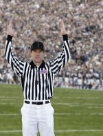 5184079-a-football-official-signals-touchdown-at-a-football-game.jpg